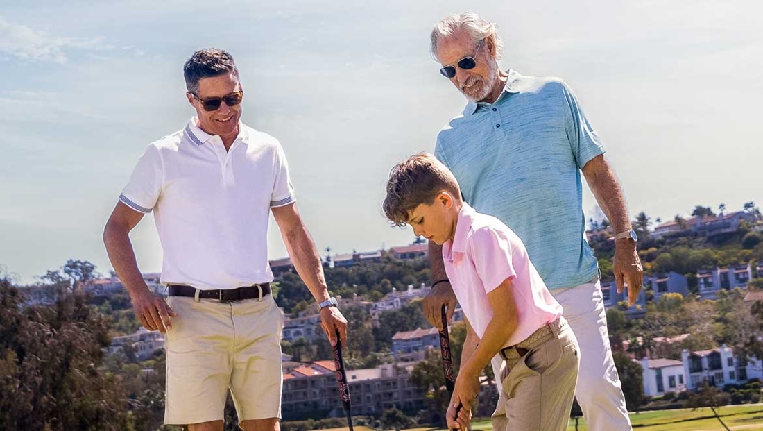 Two Men Watch a Boy Putt on the Green