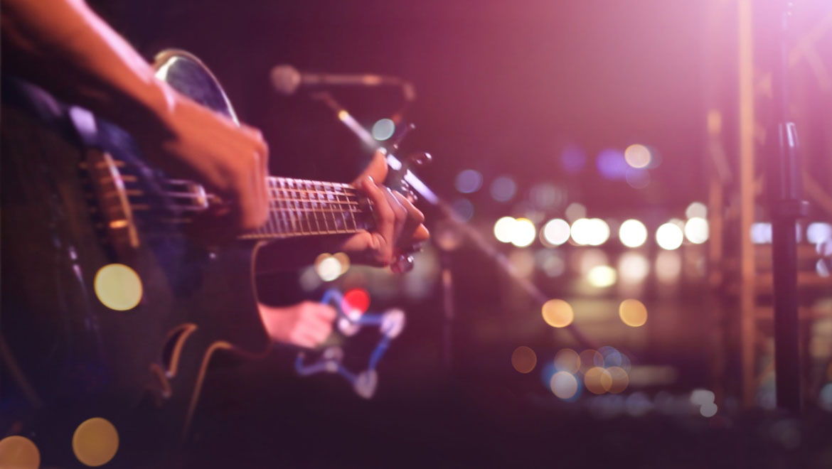 Person playing guitar onstage