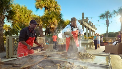 People cooking food outside. 