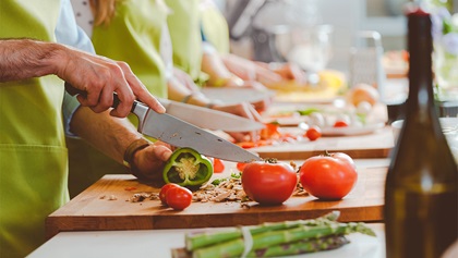 Man chopping up vegetables