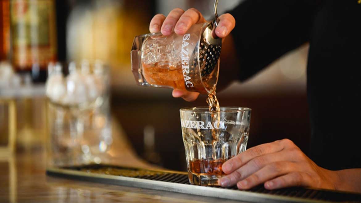 Bartender pouring out a cocktail