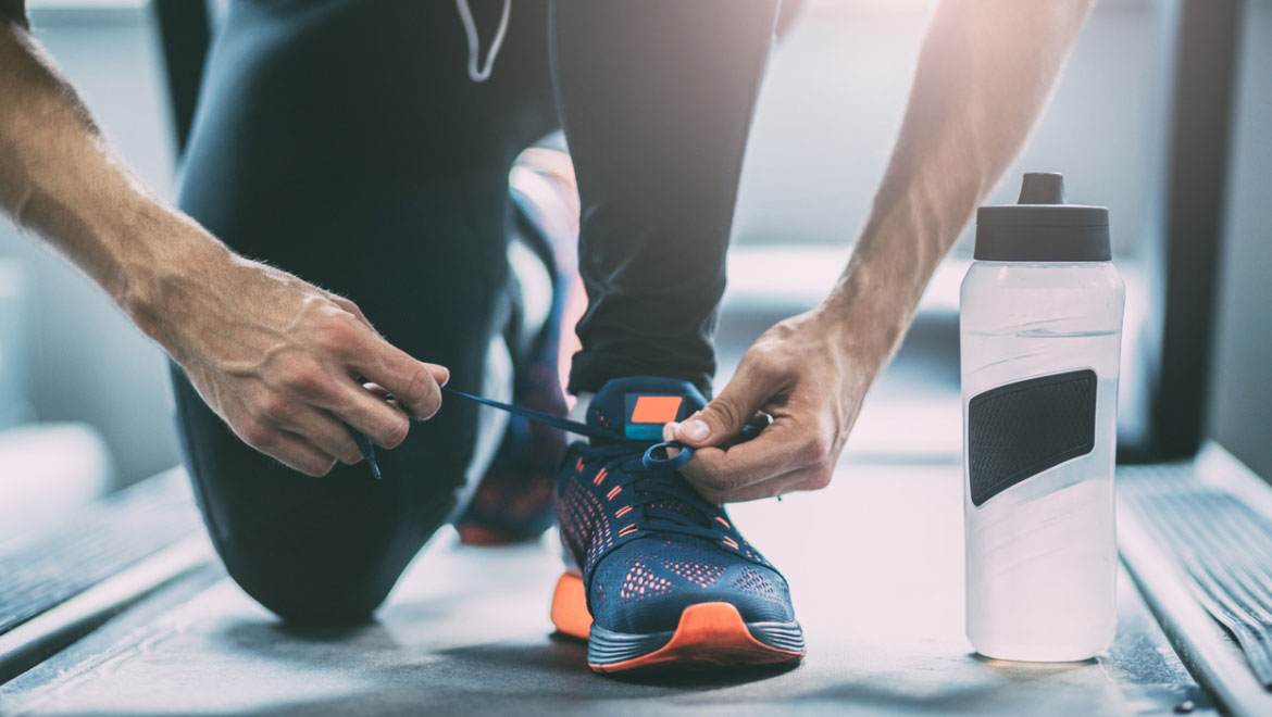 man tying shoe