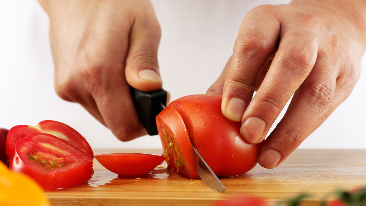 Chef cutting tomatoes