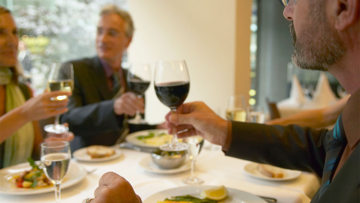 Friends eating and drinking wine