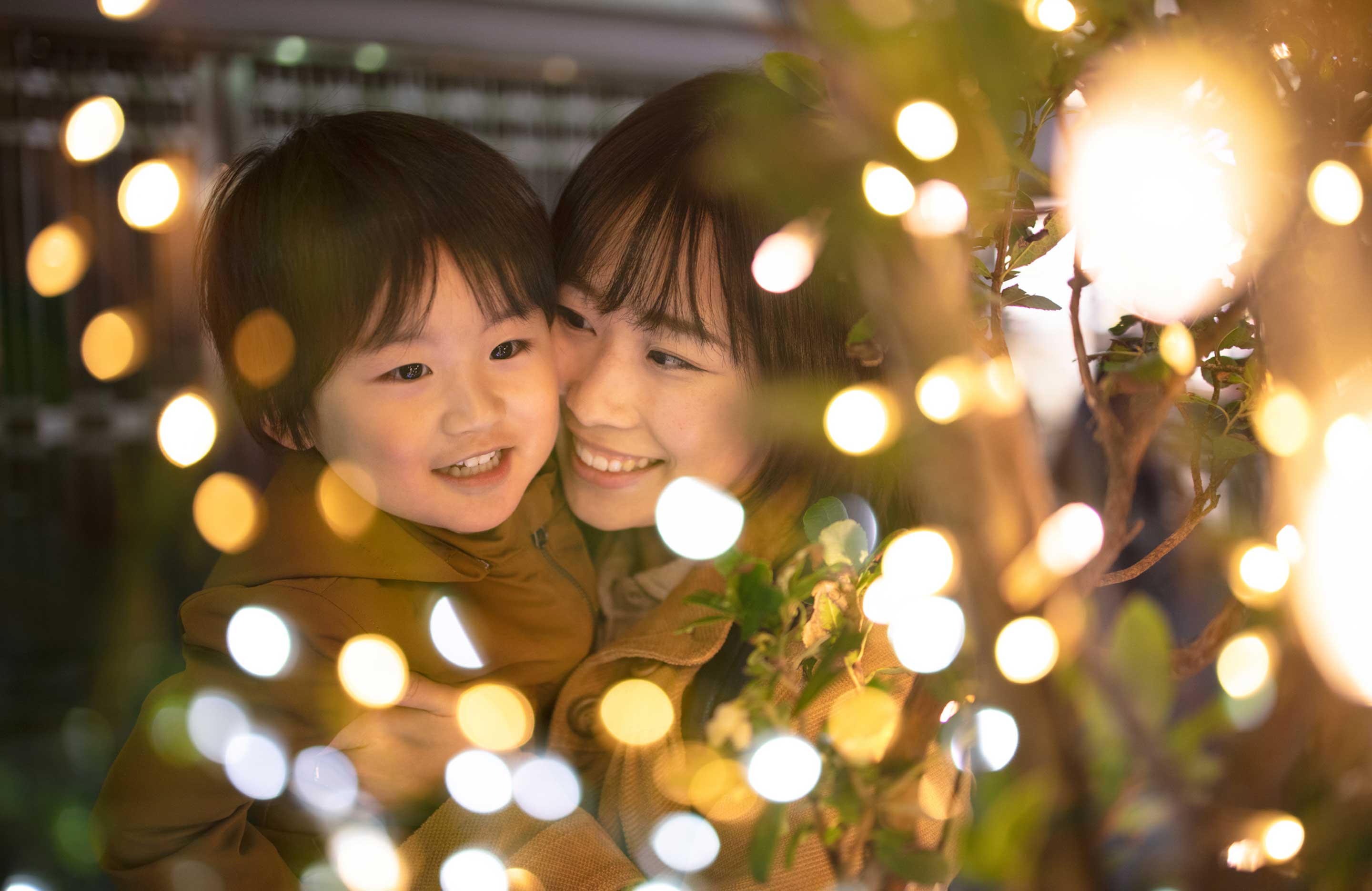 Mother and child looking at Christmas lights.