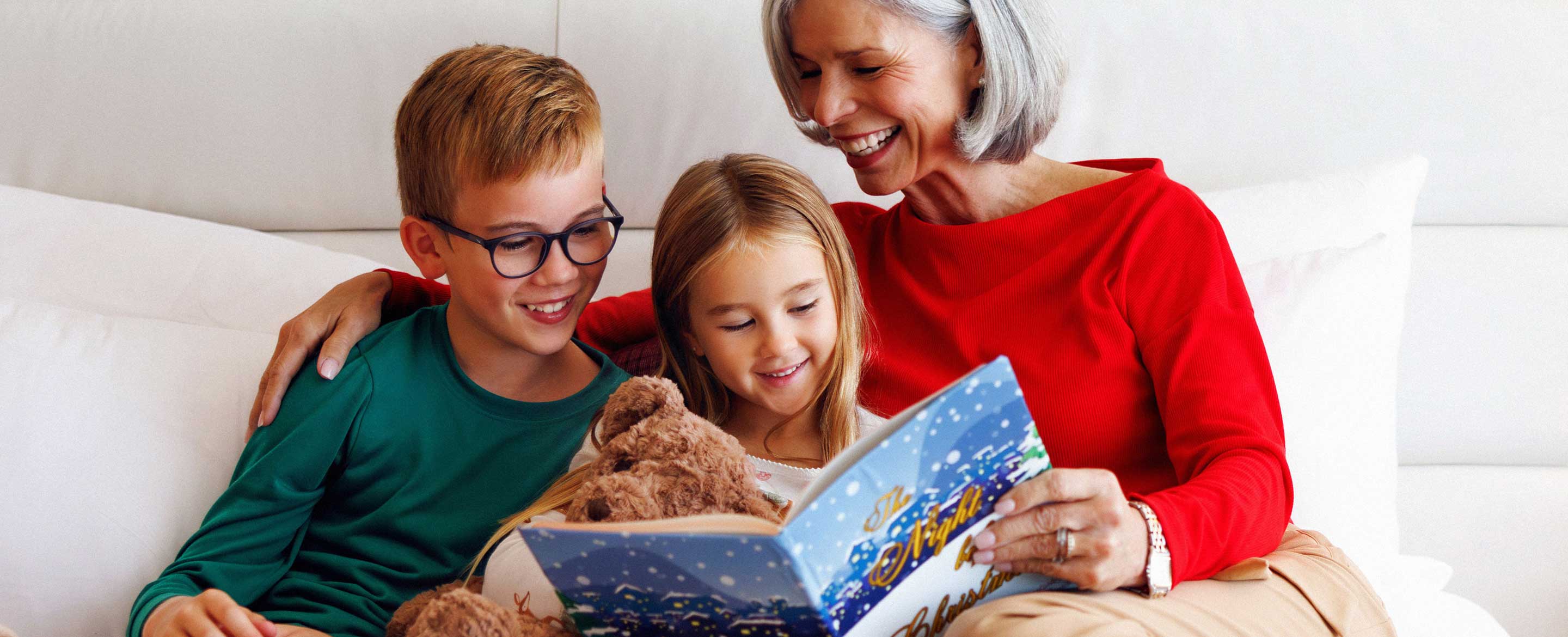 Grandma reading holiday book to kids.