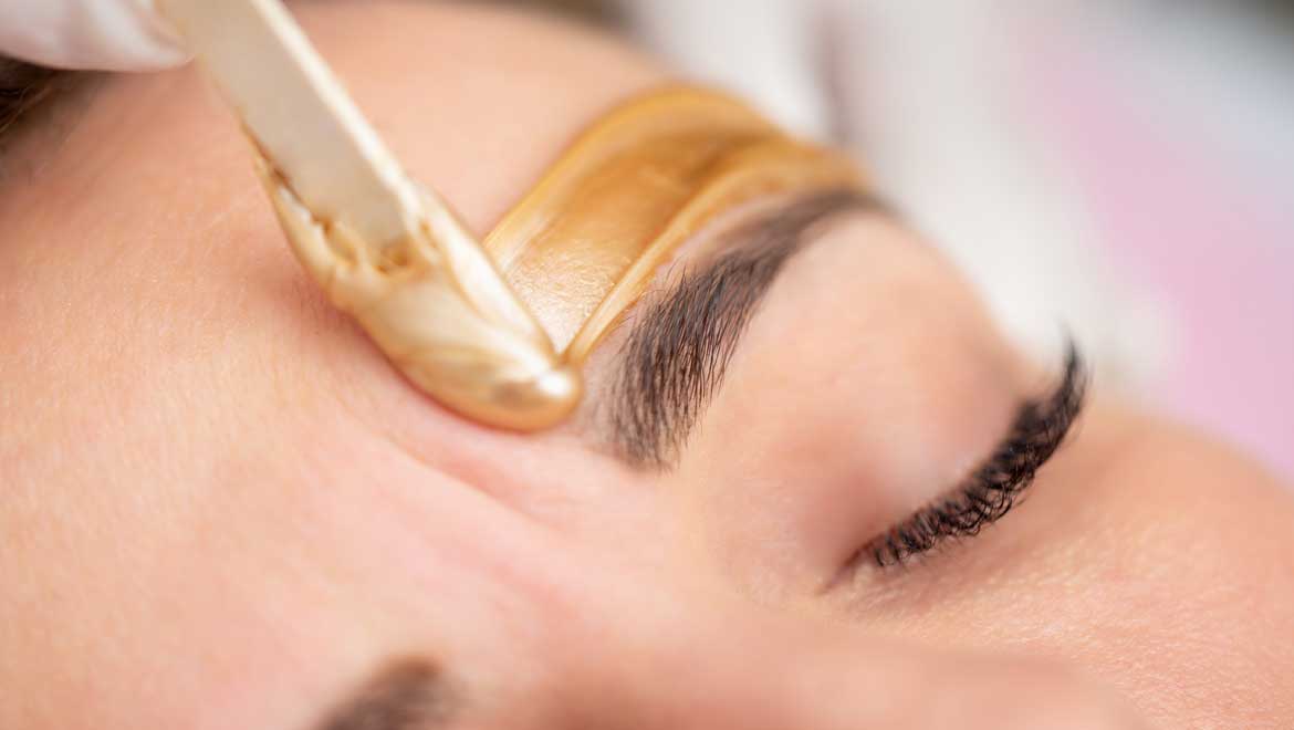 Woman getting brow waxed.