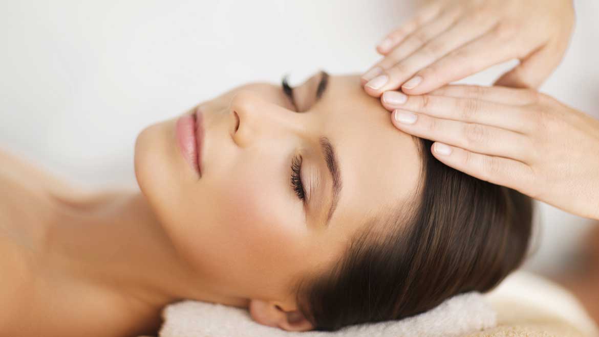 Woman receiving a face massage.