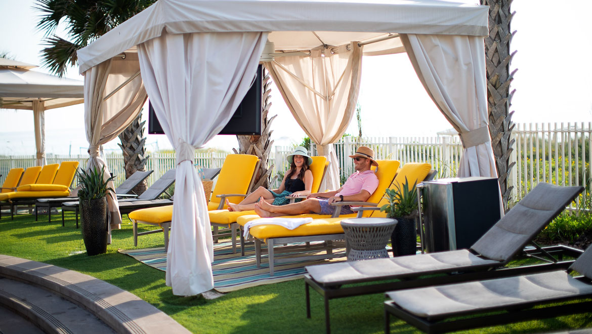 Couple lounging in cabana at  
