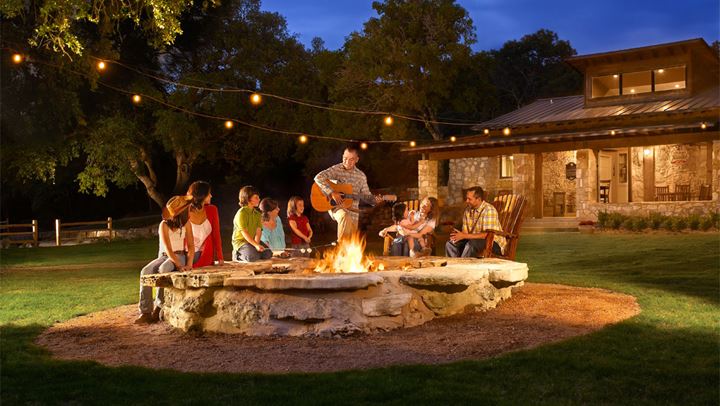 Group singalong around firepit at Barton Creek