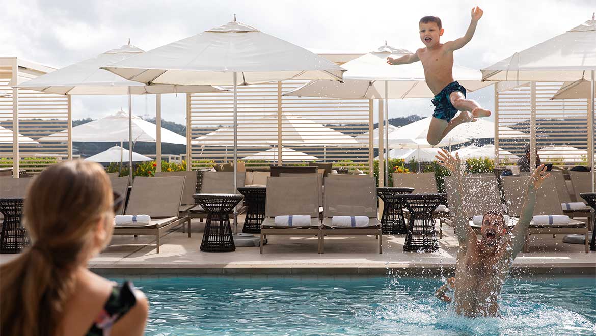 Family playing in the pool