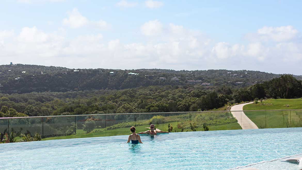 Couple swimming in infinity pool