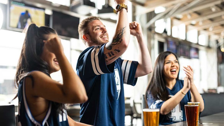 People cheering at the bar.