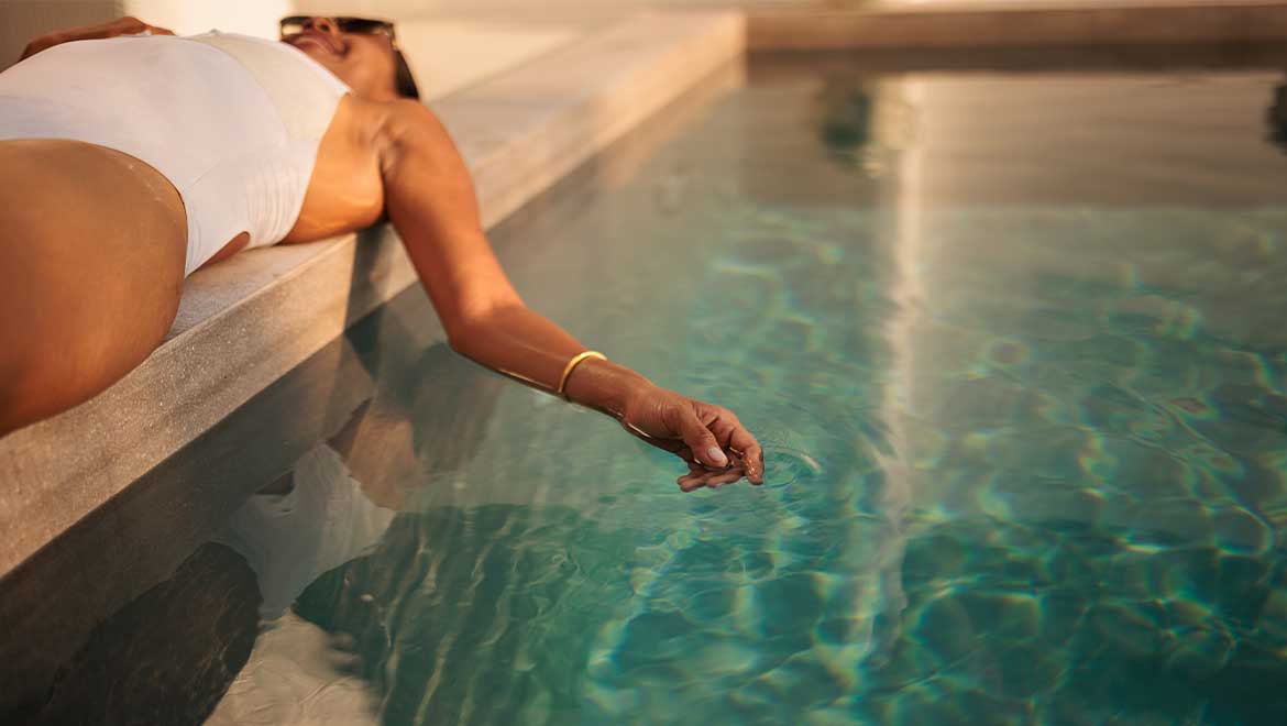Woman laying by the pool