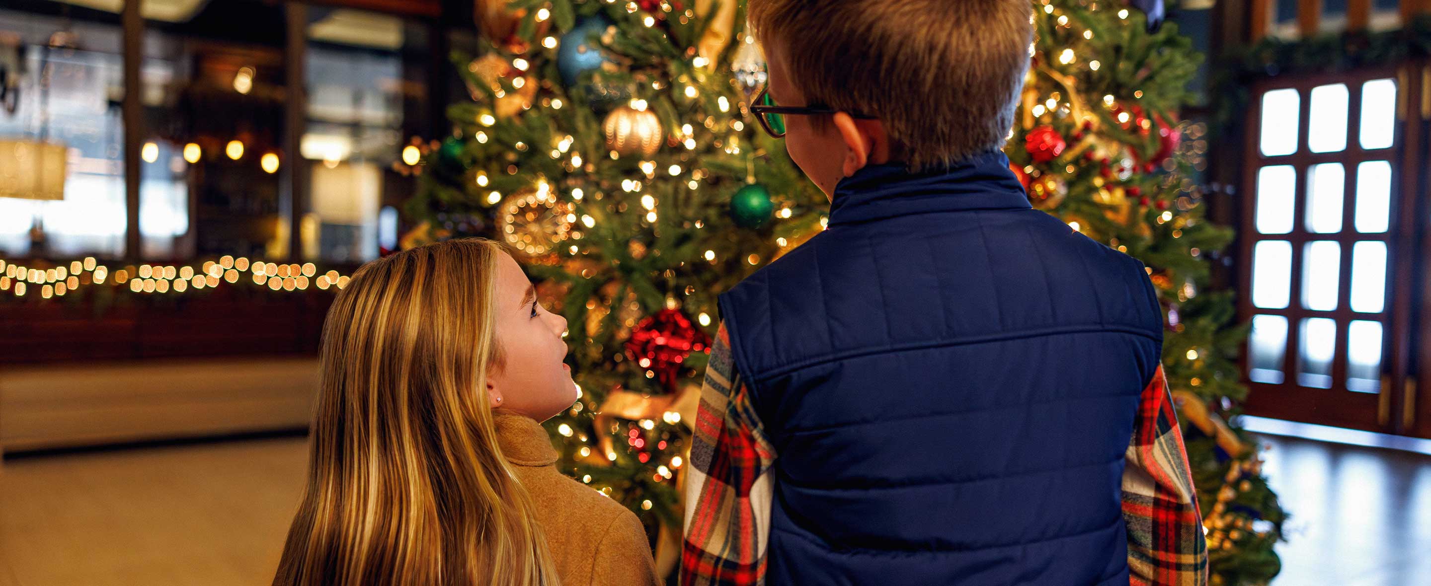 Kids looking at Christmas tree