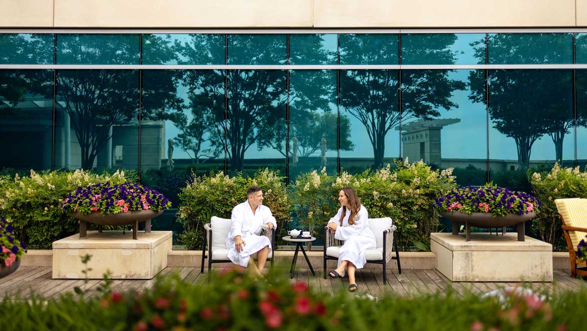 Couple on beautiful spa patio drinking tea.