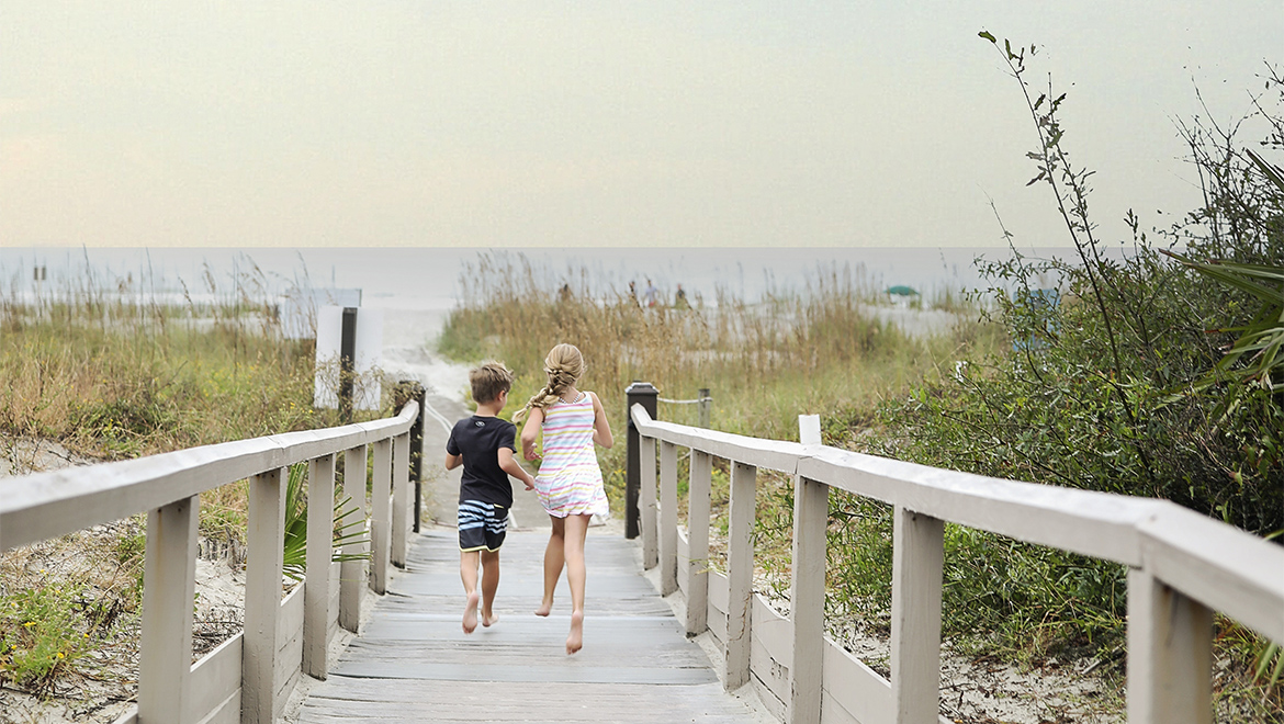 Children running down boardwalk