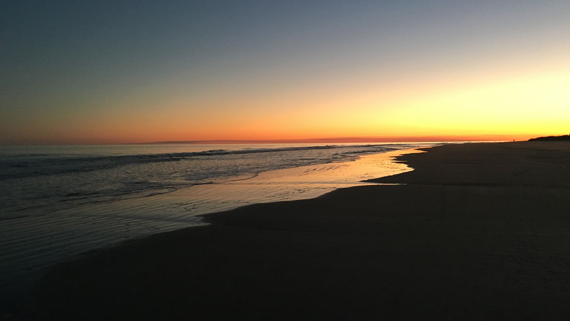 orange sunset on the beach outside the Omni Resort