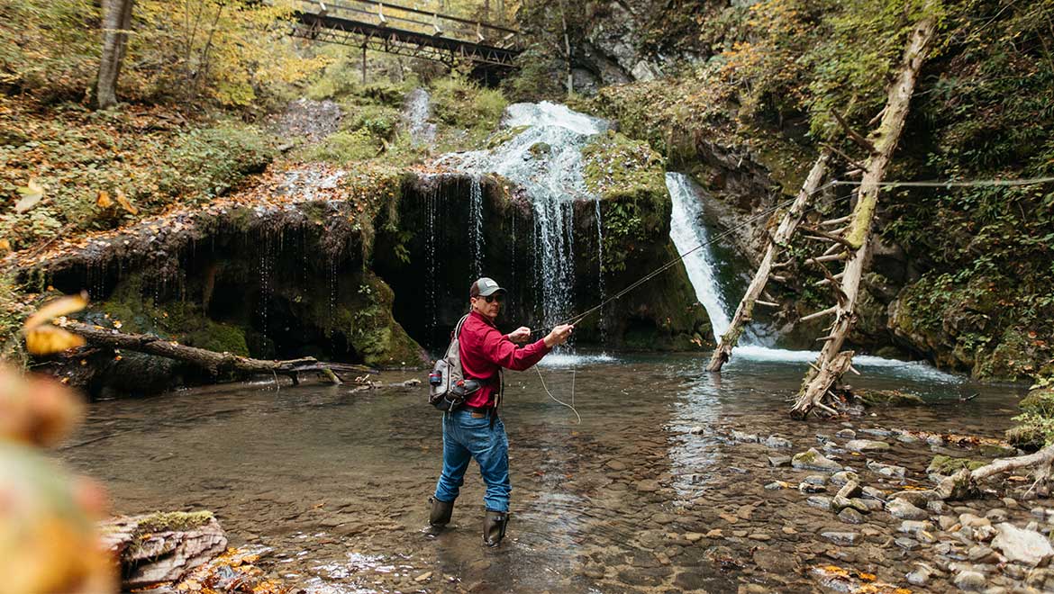 Man fly fishing at Omni Homestead Resort