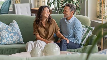 People visiting on the couch in the lobby.