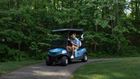Man driving a golf cart.