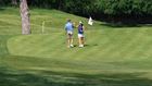 Couple high five on the putting green.