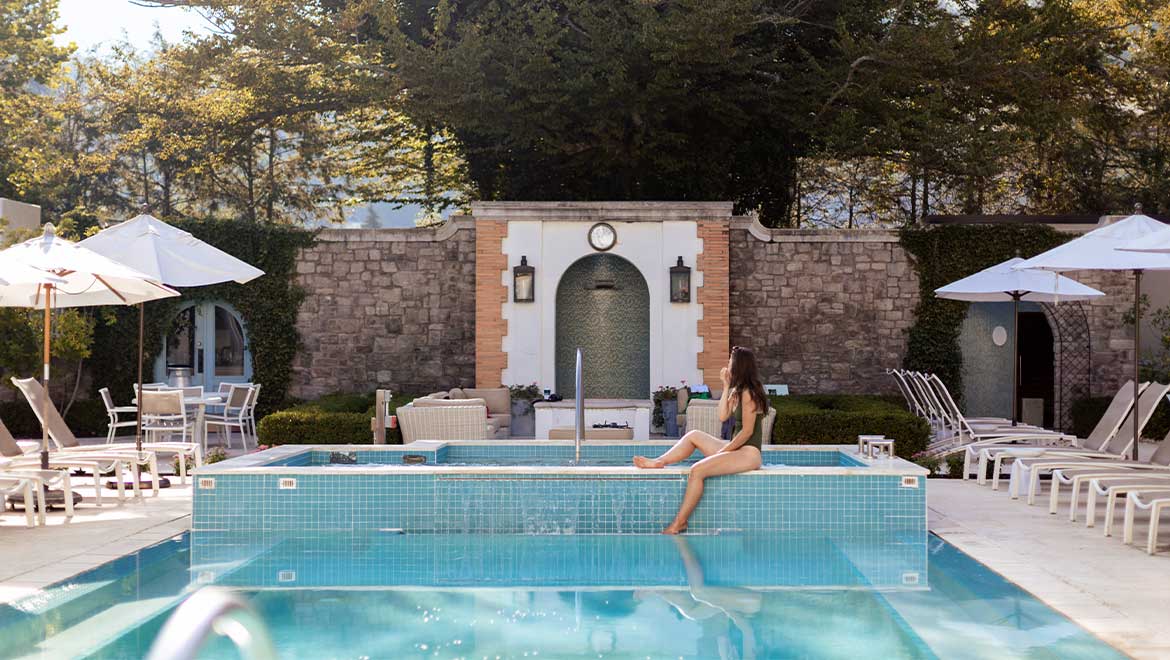 Woman sitting poolside