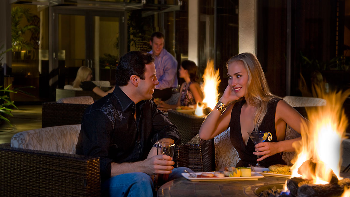 Couple sitting by fire pit in Houston 