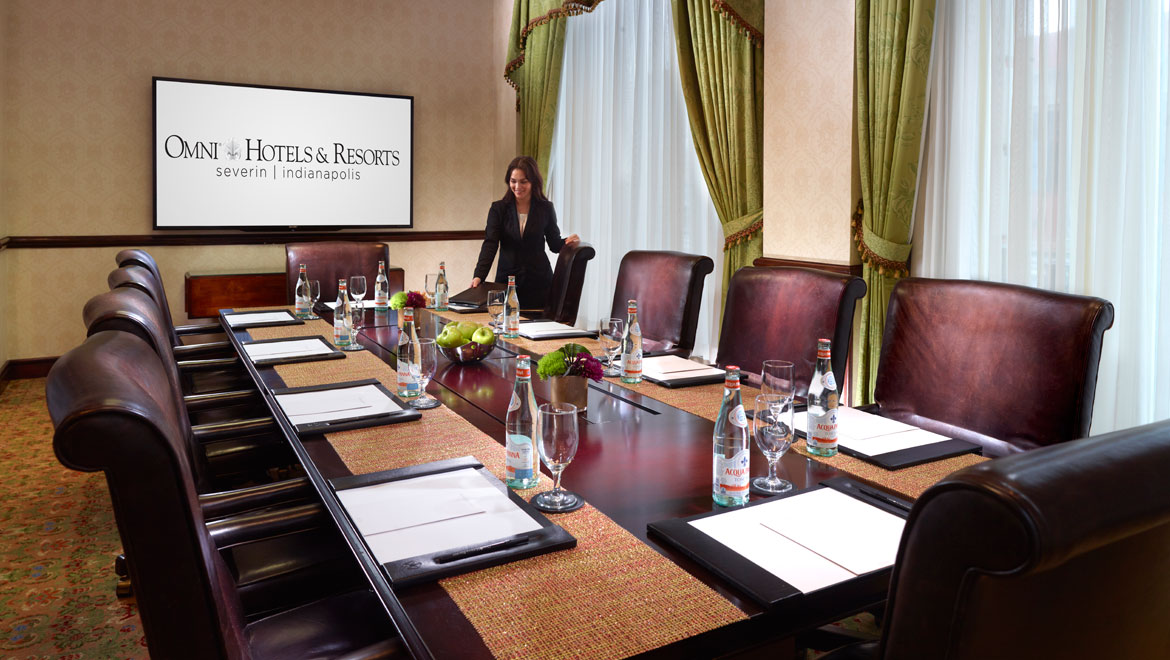 Associate setting up meeting in boardroom