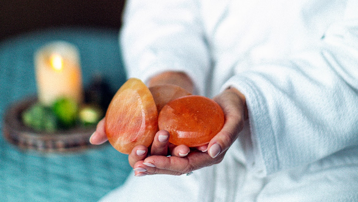 woman holding stones at spa
