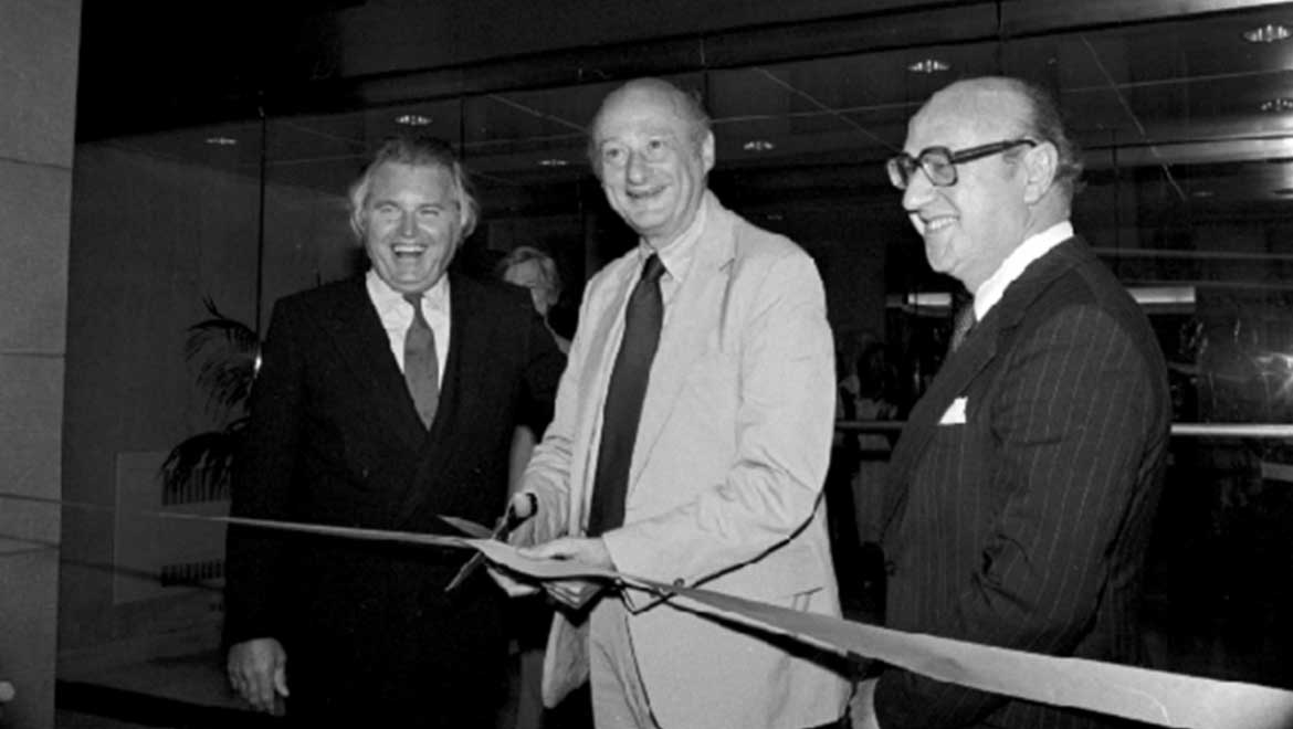 Man cutting ribbon at a ribbon ceremony