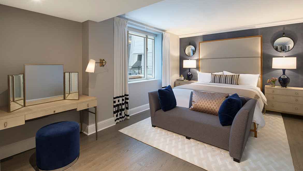 Penthouse bedroom with couch.