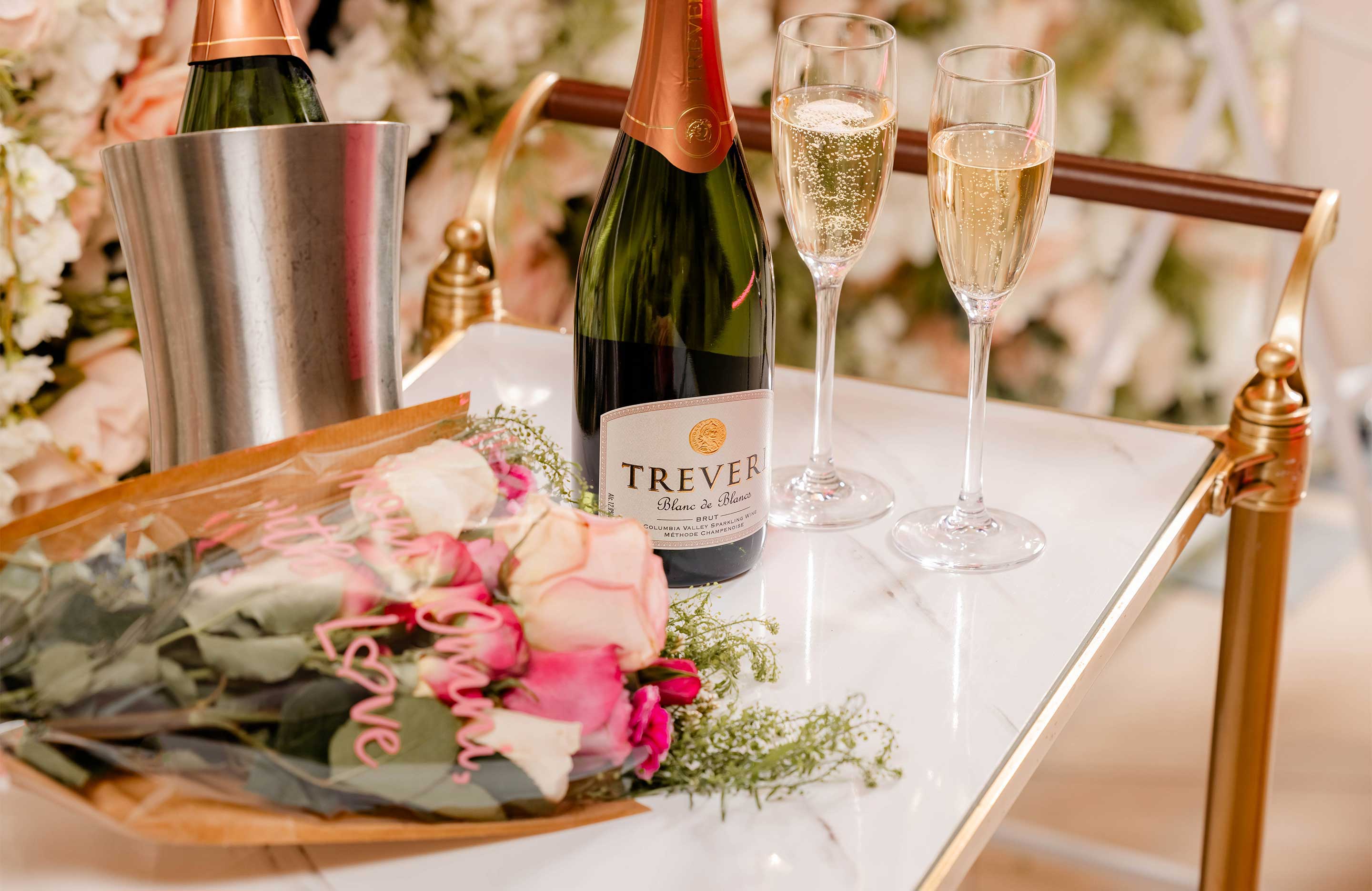 Bar cart with champagne and flower bouquet