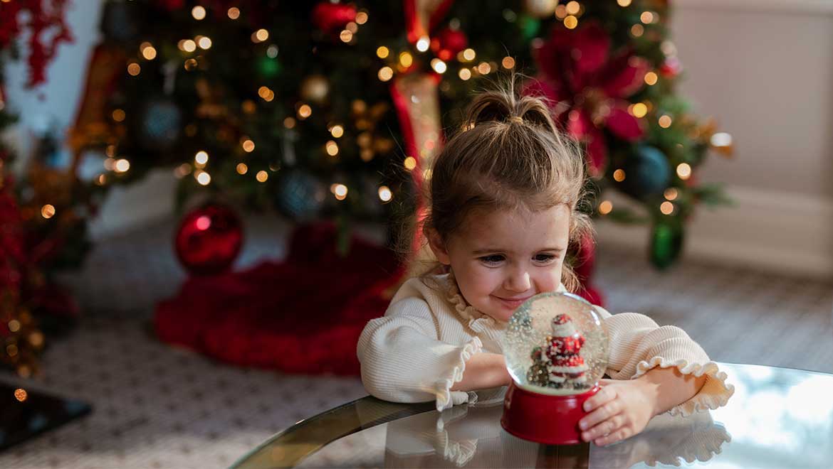 Little girl holding a snowglobe