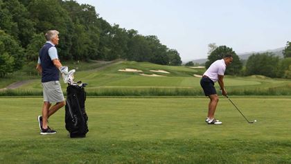 Man teeing off.
