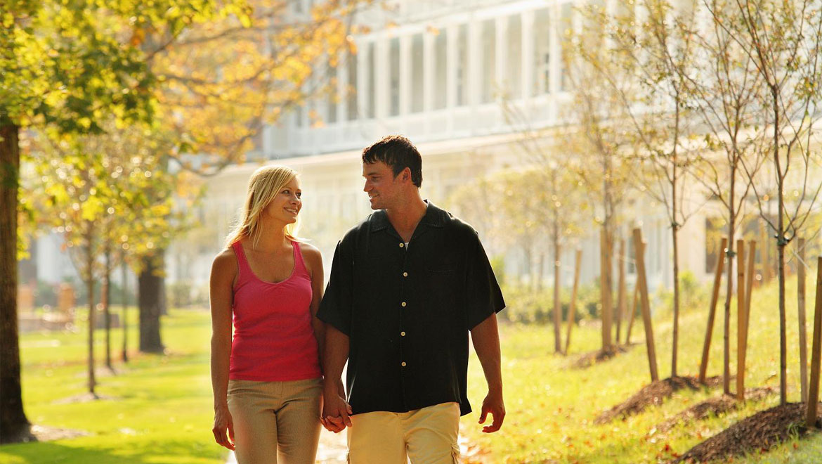 Couple walking through the park in Bedford Springs
