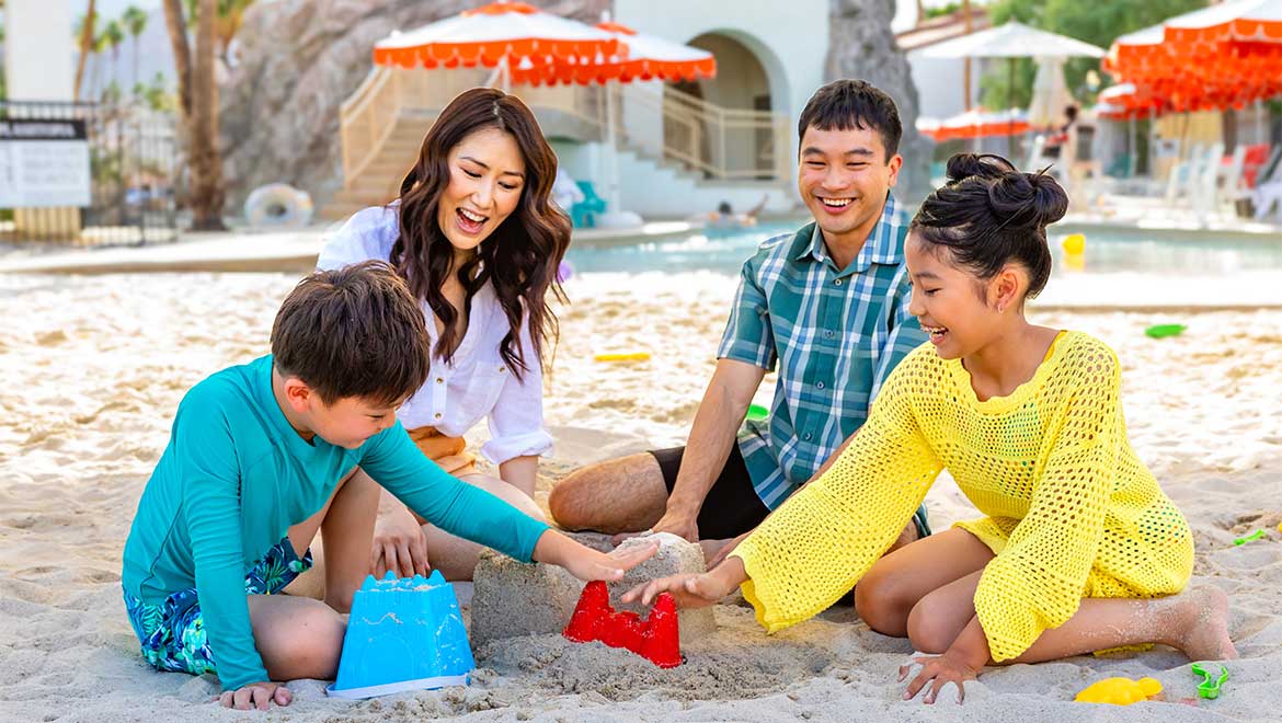 Family building a sand castle 