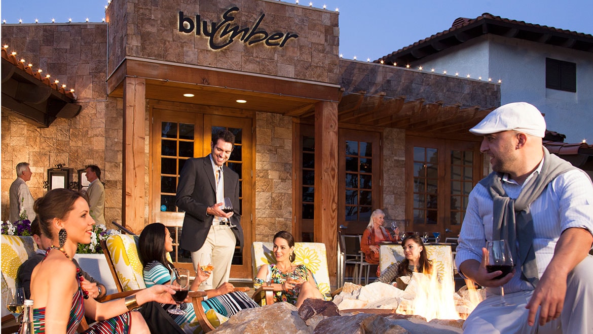 People dining on restaurant patio.
