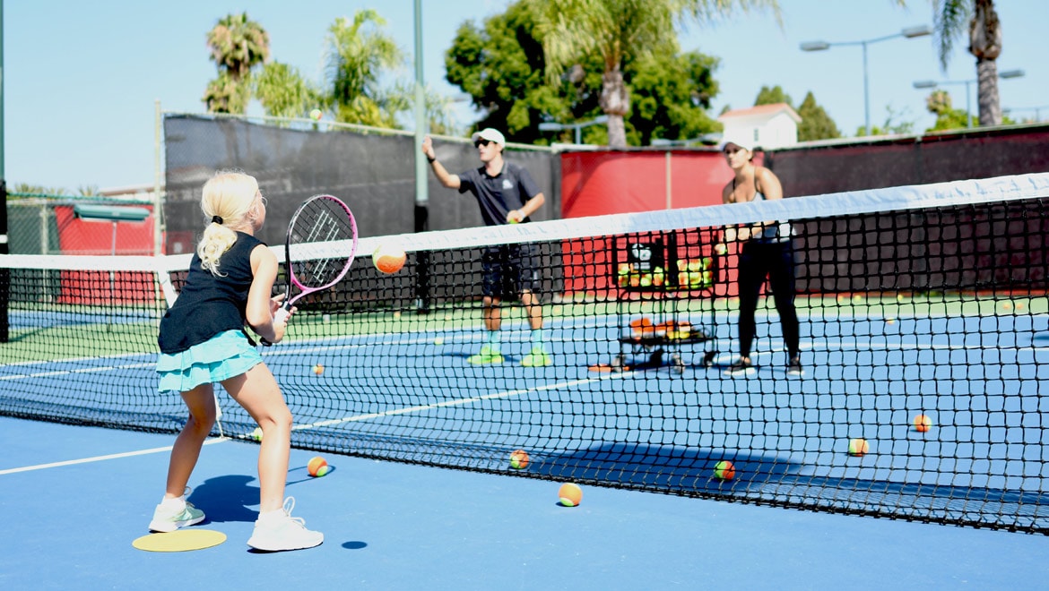Little girl playing tennis