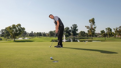 Man putting on the putting green.