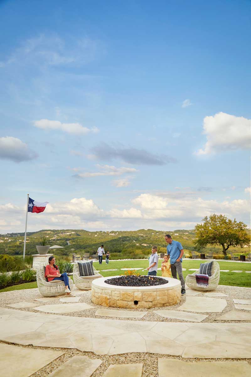 Family gathered by a fire pit
